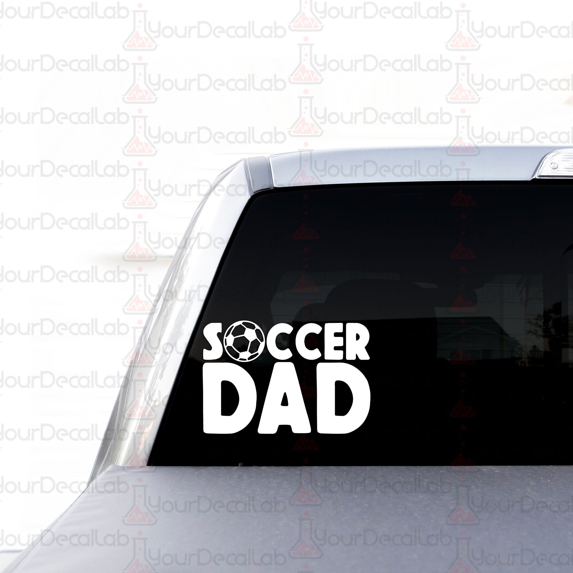 a sticker on the back of a car that says soccer dad