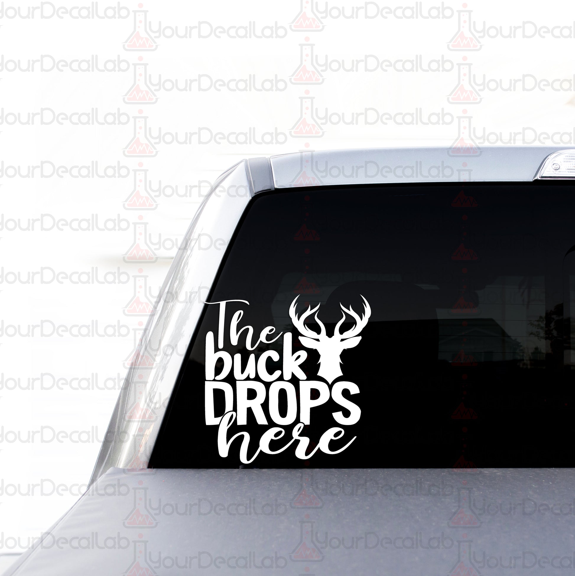 the buck drops here sticker on the back of a car