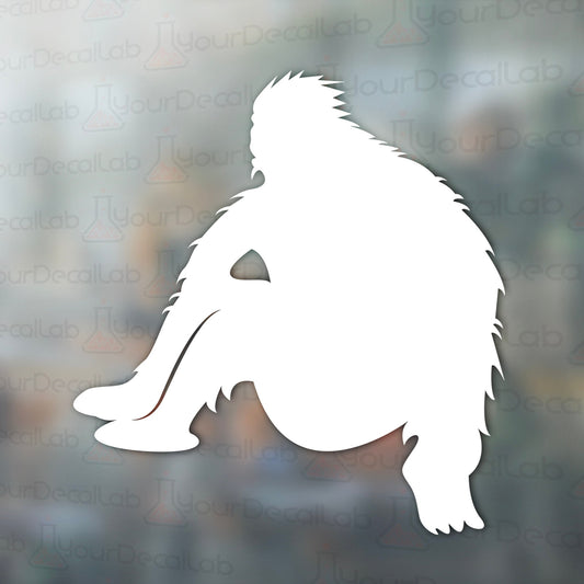a white silhouette of a squatting gorilla on a blurry background