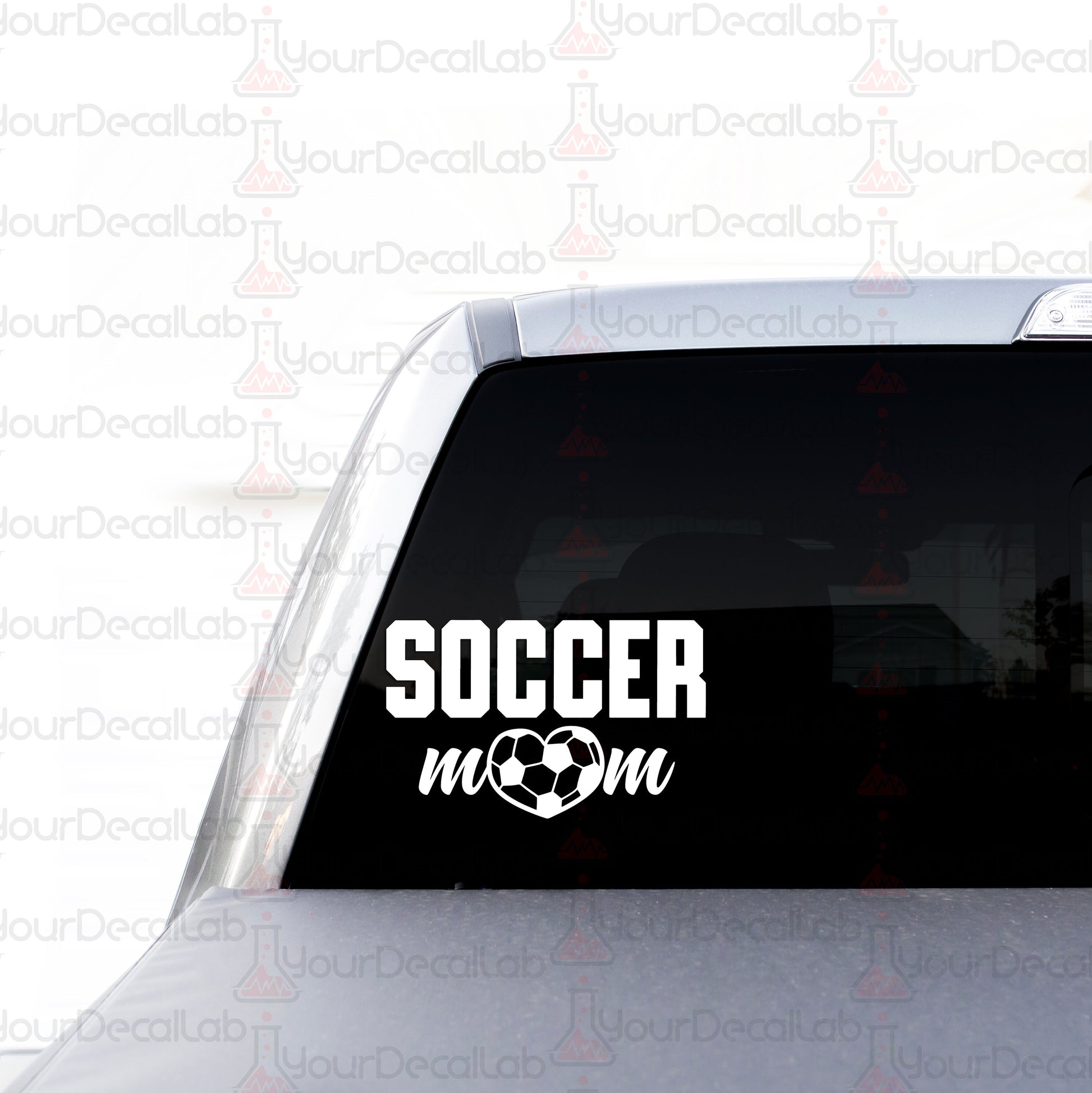 a soccer mom decal on the back of a car