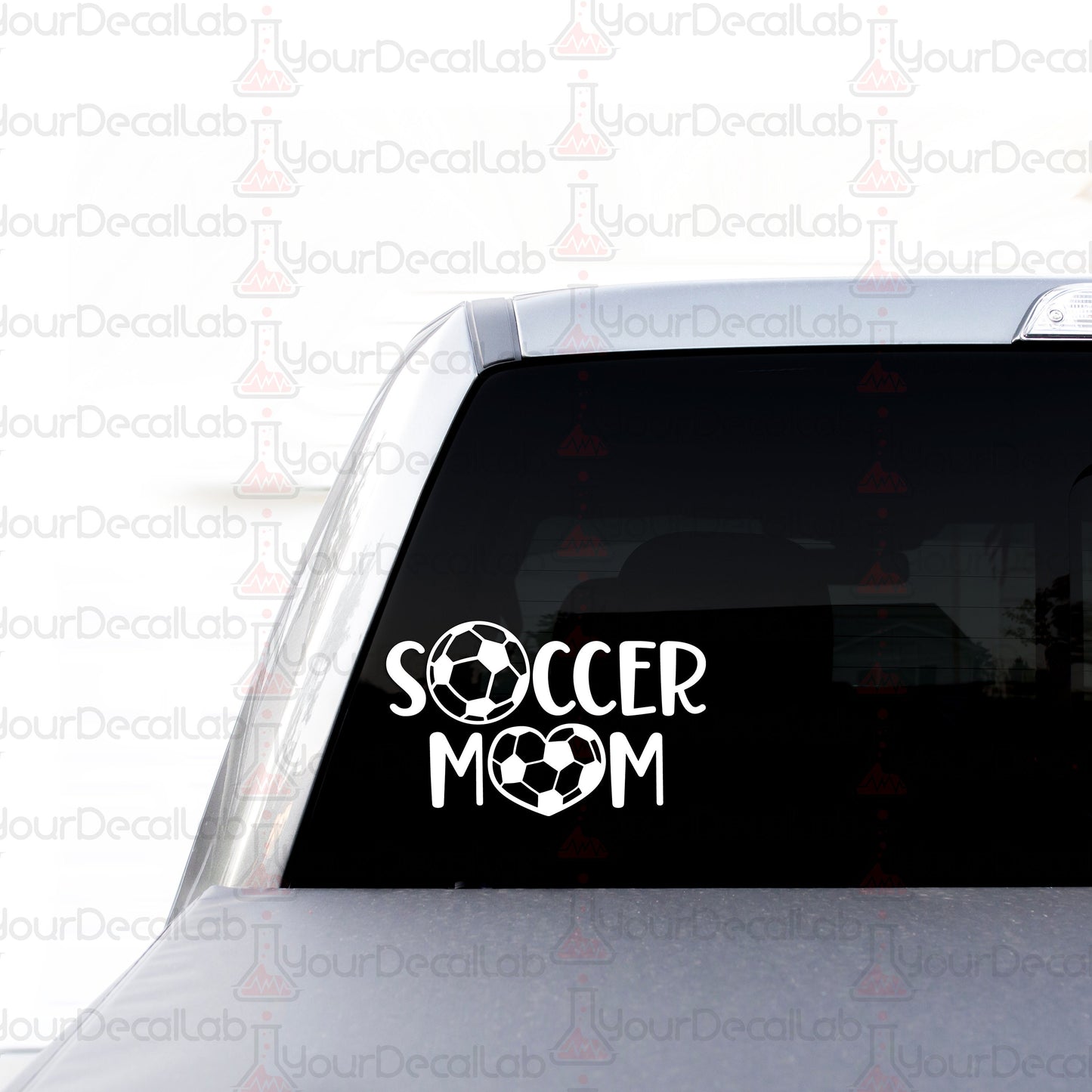 a soccer mom sticker on the back of a car