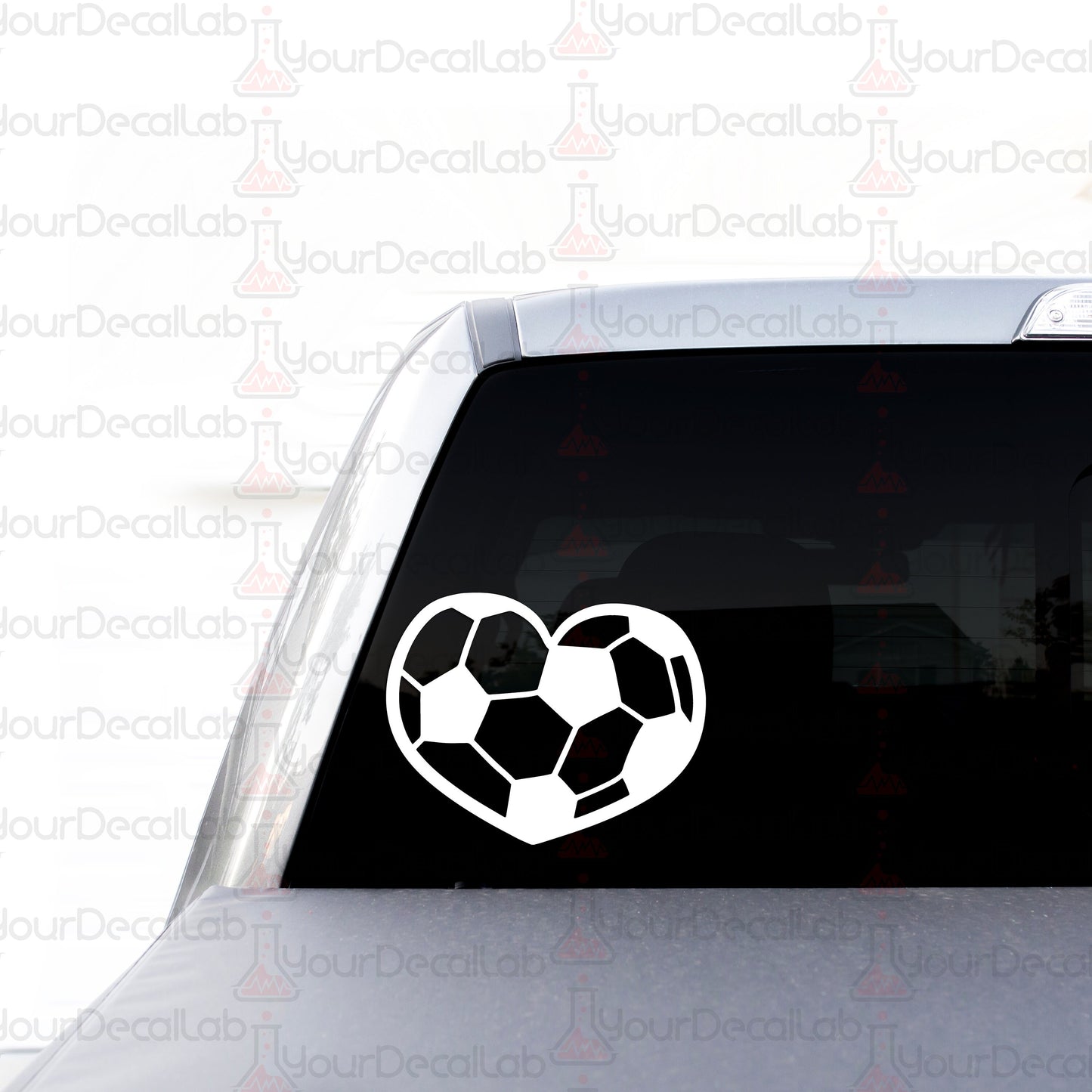 a heart shaped soccer ball sticker on the back of a car