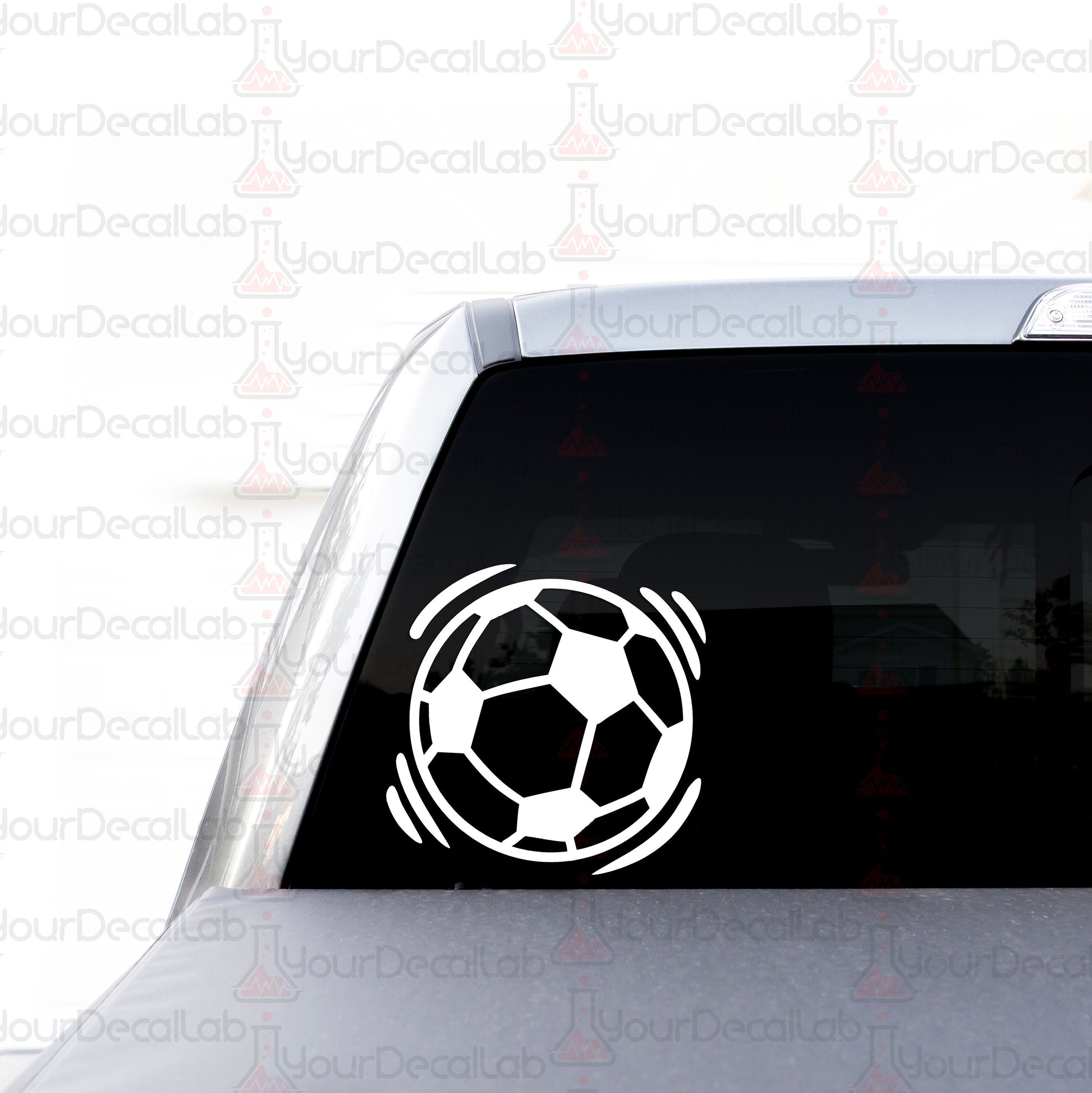 a sticker of a soccer ball on the back of a car