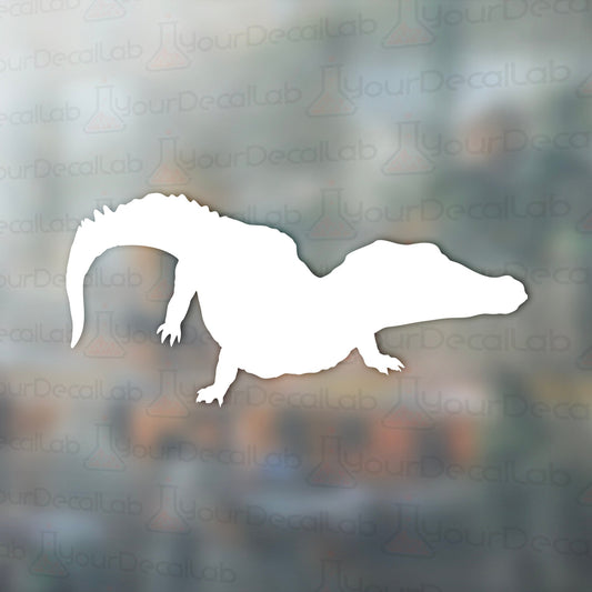 a silhouette of a lizard on a blurry background