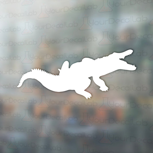a silhouette of a crocodile on a blurry background