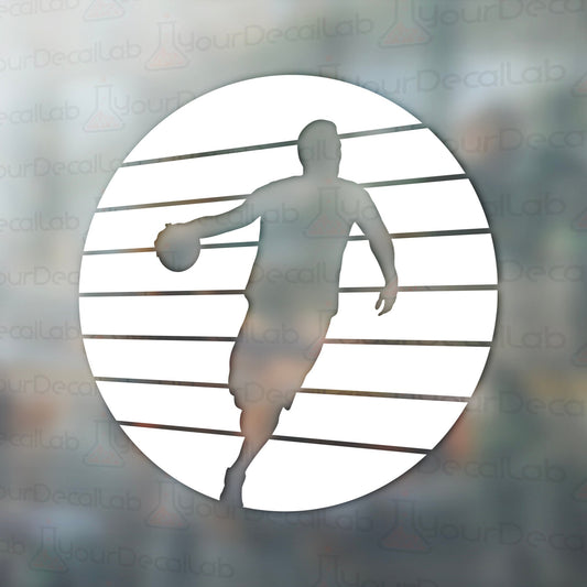 a silhouette of a basketball player holding a ball