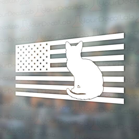 a cat sitting on top of an american flag