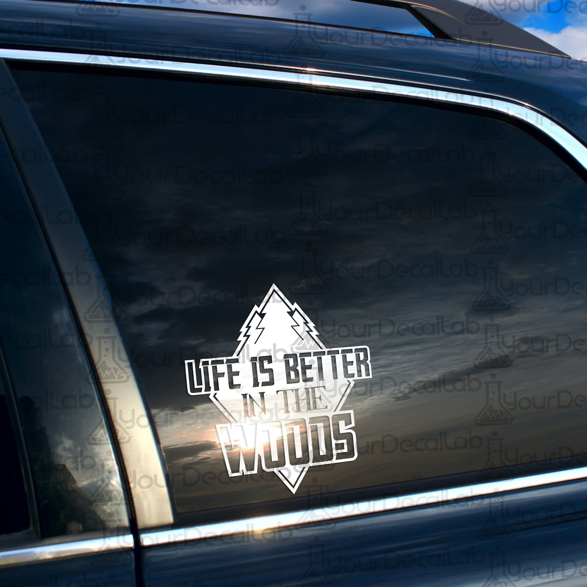 a car with a sticker that says life is better in the woods