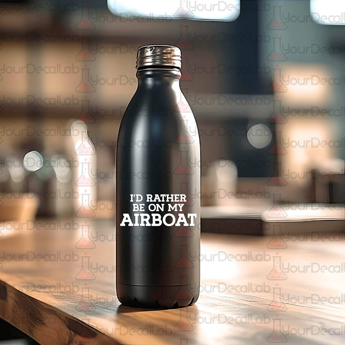 a black water bottle sitting on top of a wooden table