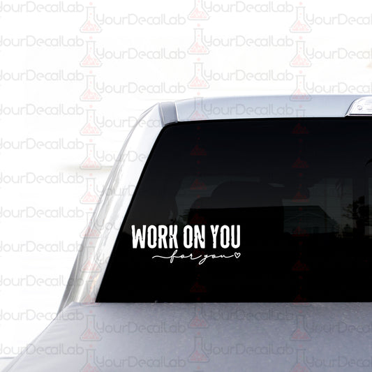 a sticker on the back of a car that says work on you