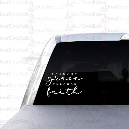 a sticker on the back of a car that says saved by grace through faith