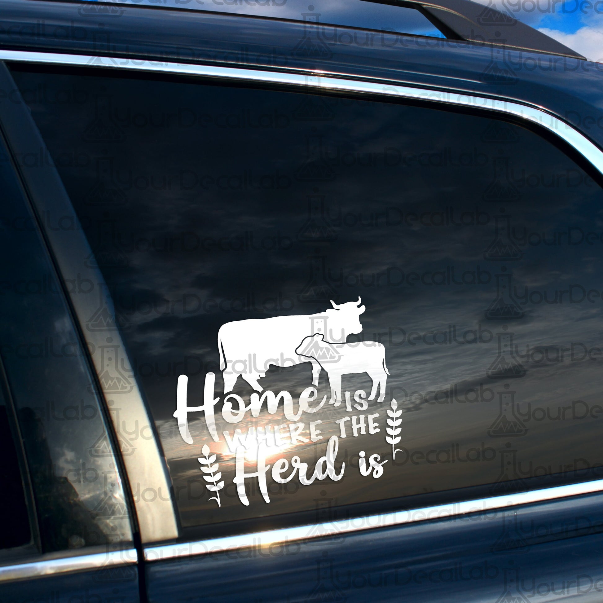 a car with a sticker that says home is where the herd is