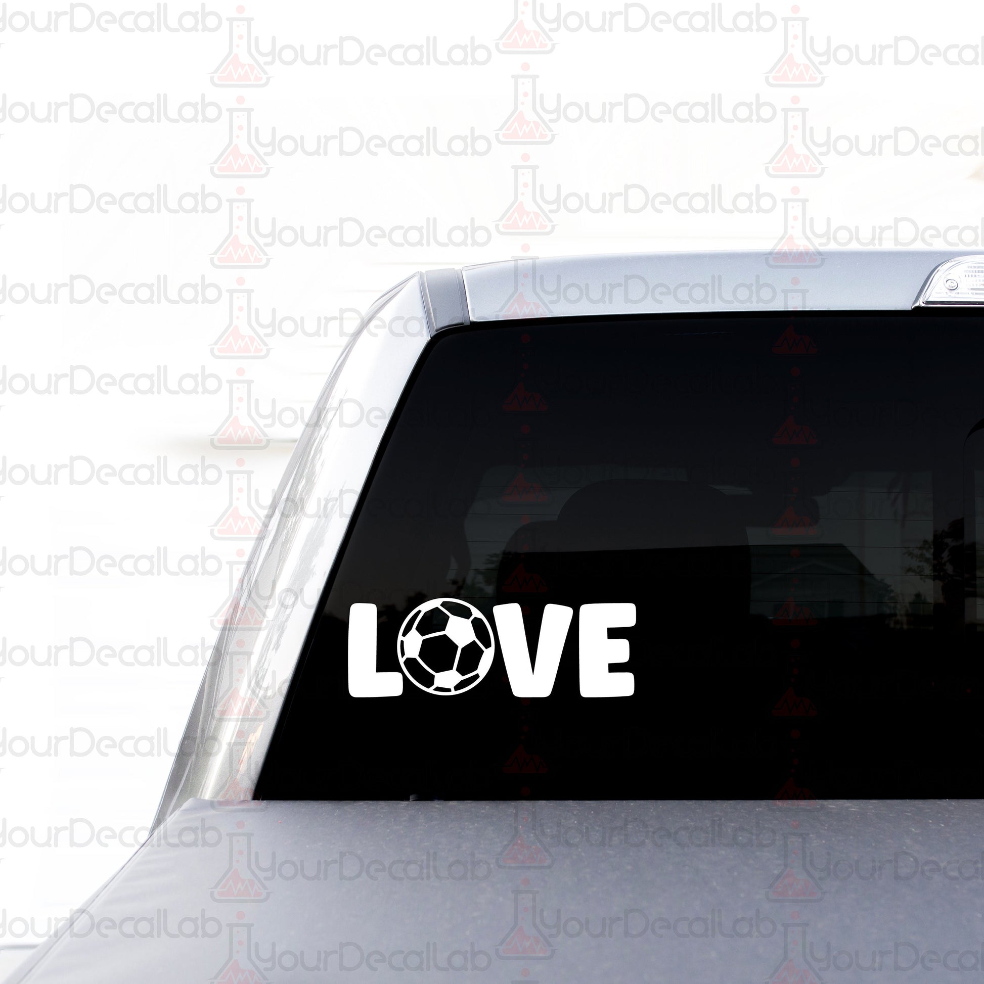 a car with a sticker that says love with a soccer ball