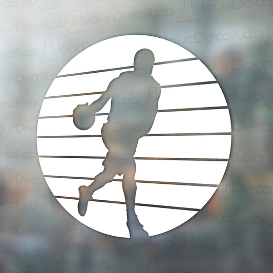 a silhouette of a basketball player holding a ball