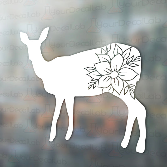 a deer with a flower in its antlers