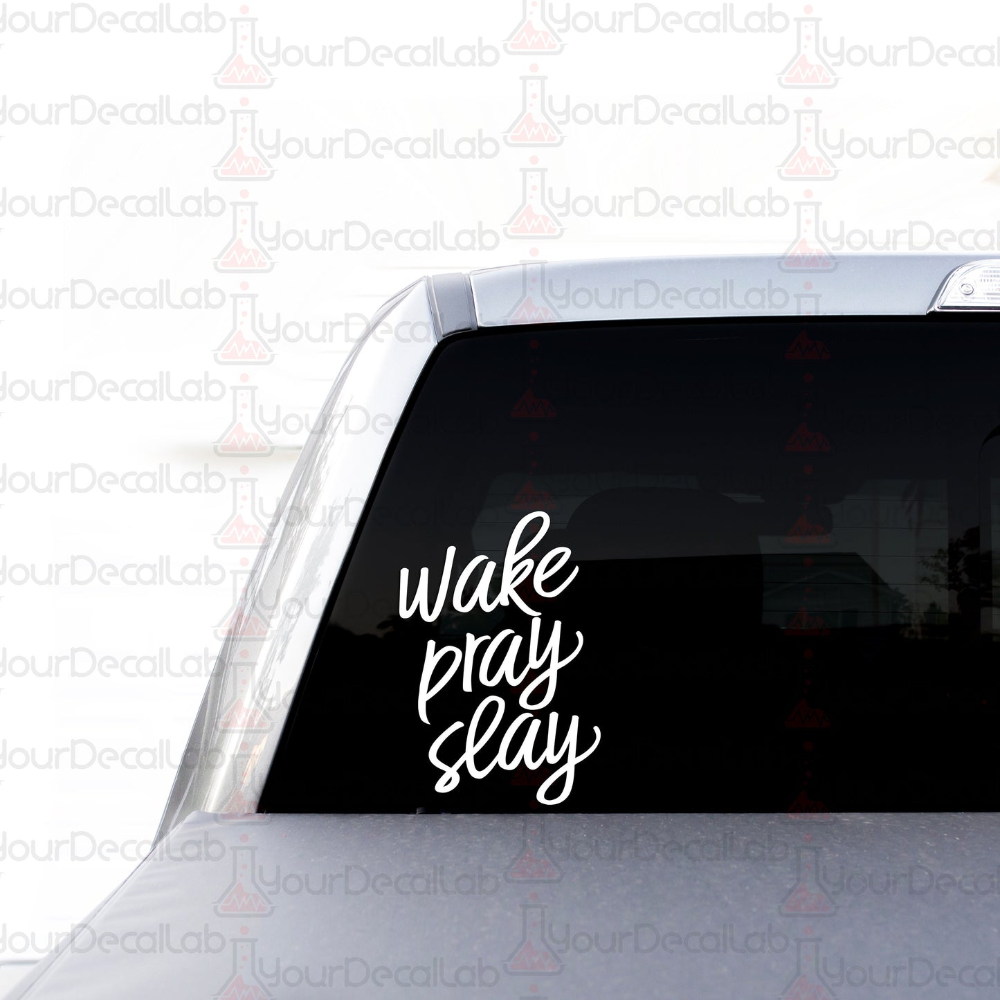 a car with a sticker that says wake pray slay