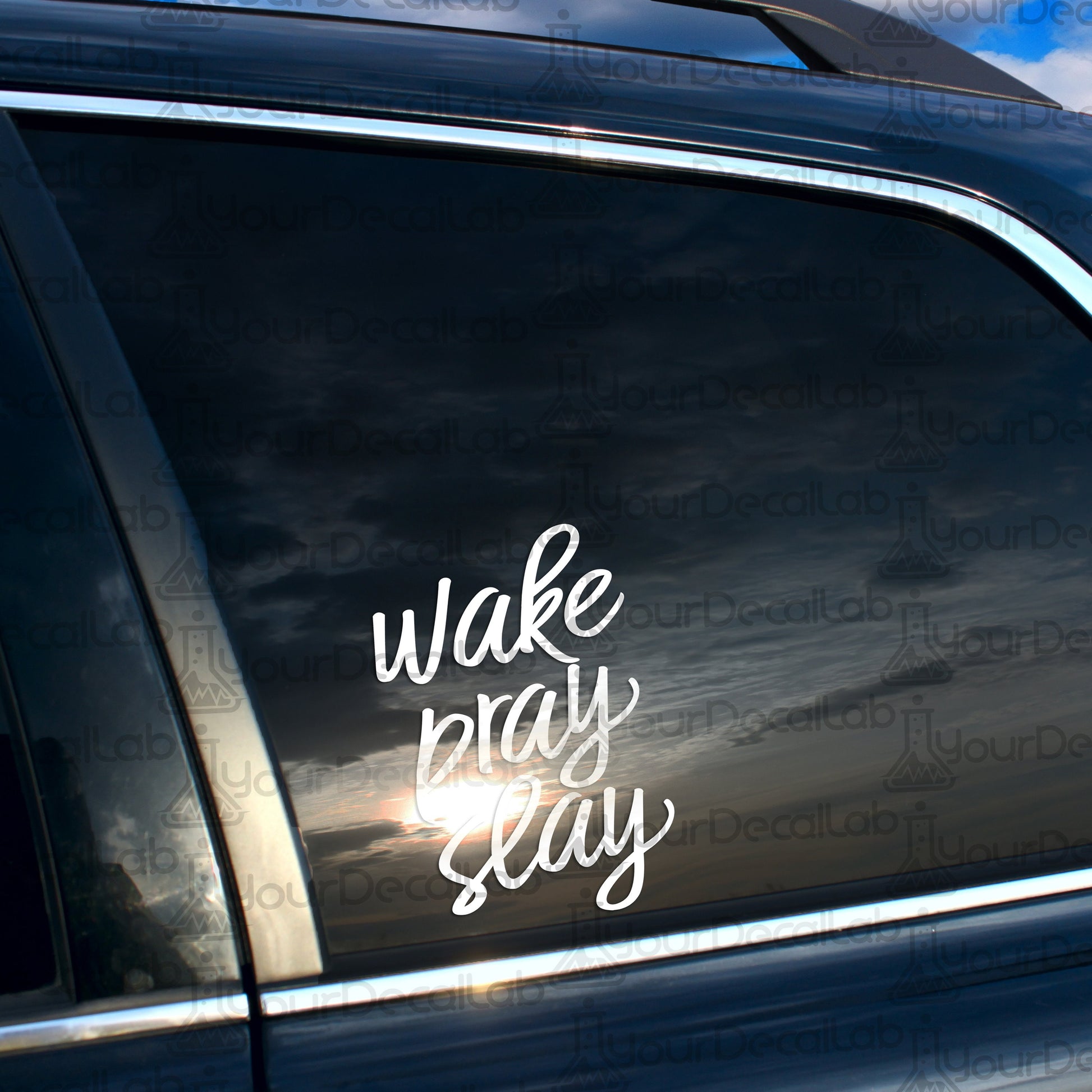 a car with a wake pray slay sticker on it