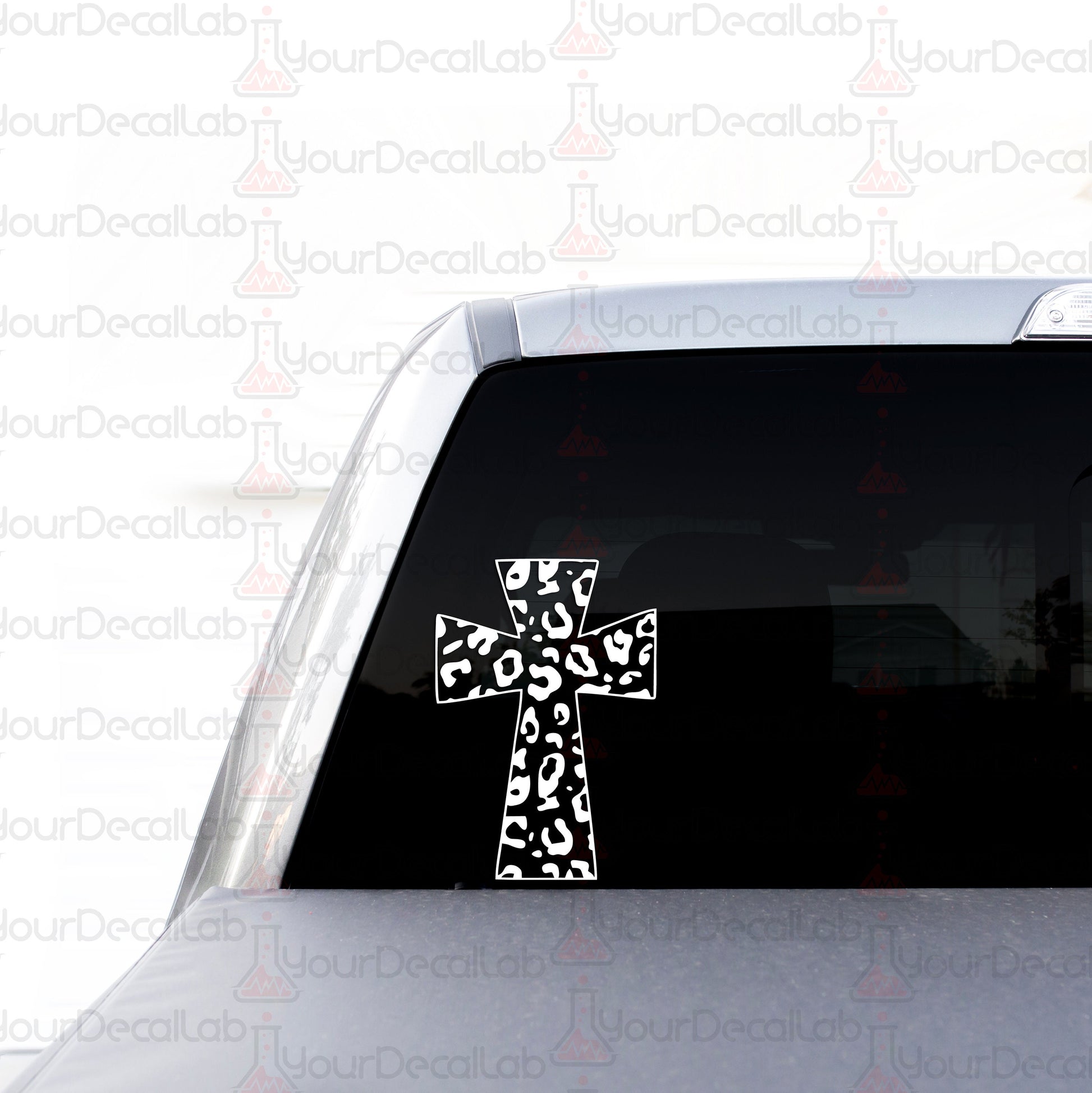 a sticker of a cross on the back of a car