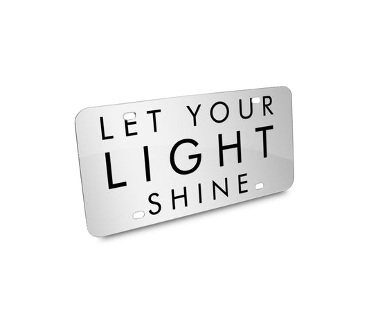 a white license plate that says let your light shine